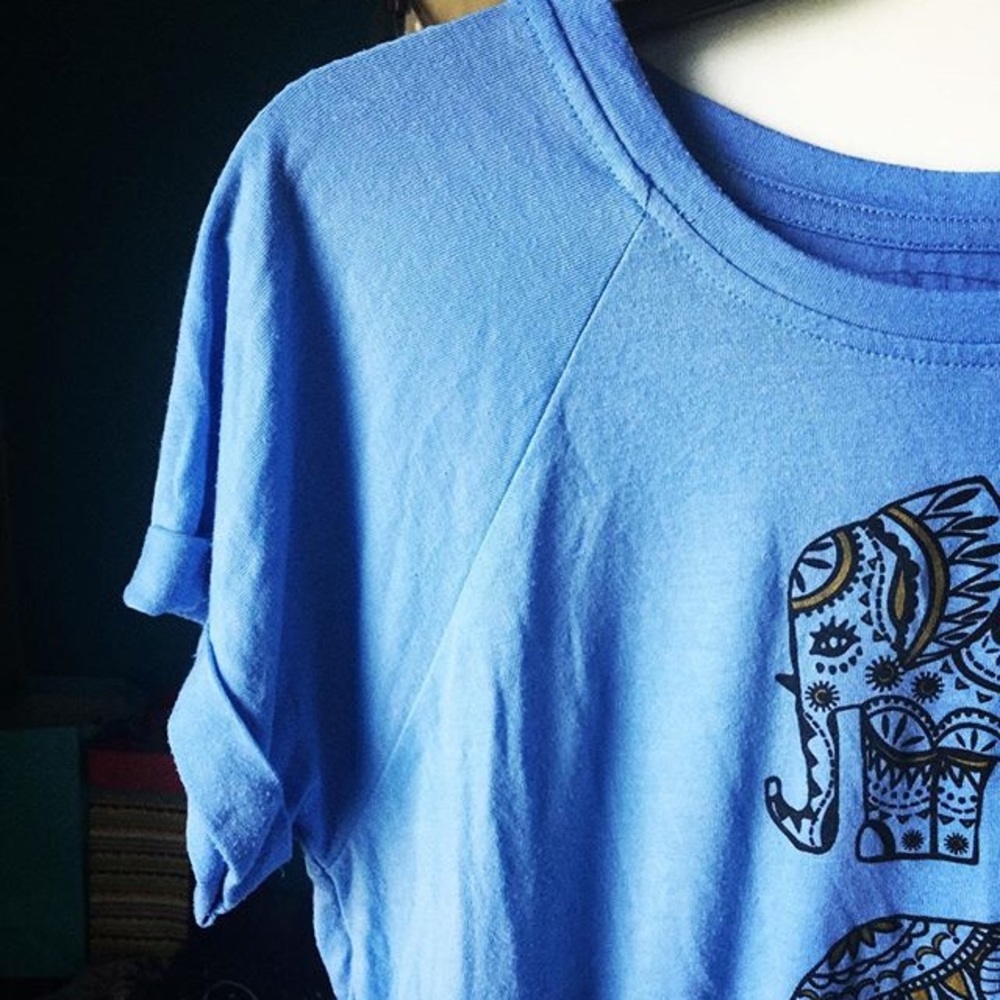 Light blue t shirt with 3 black and gold elephants